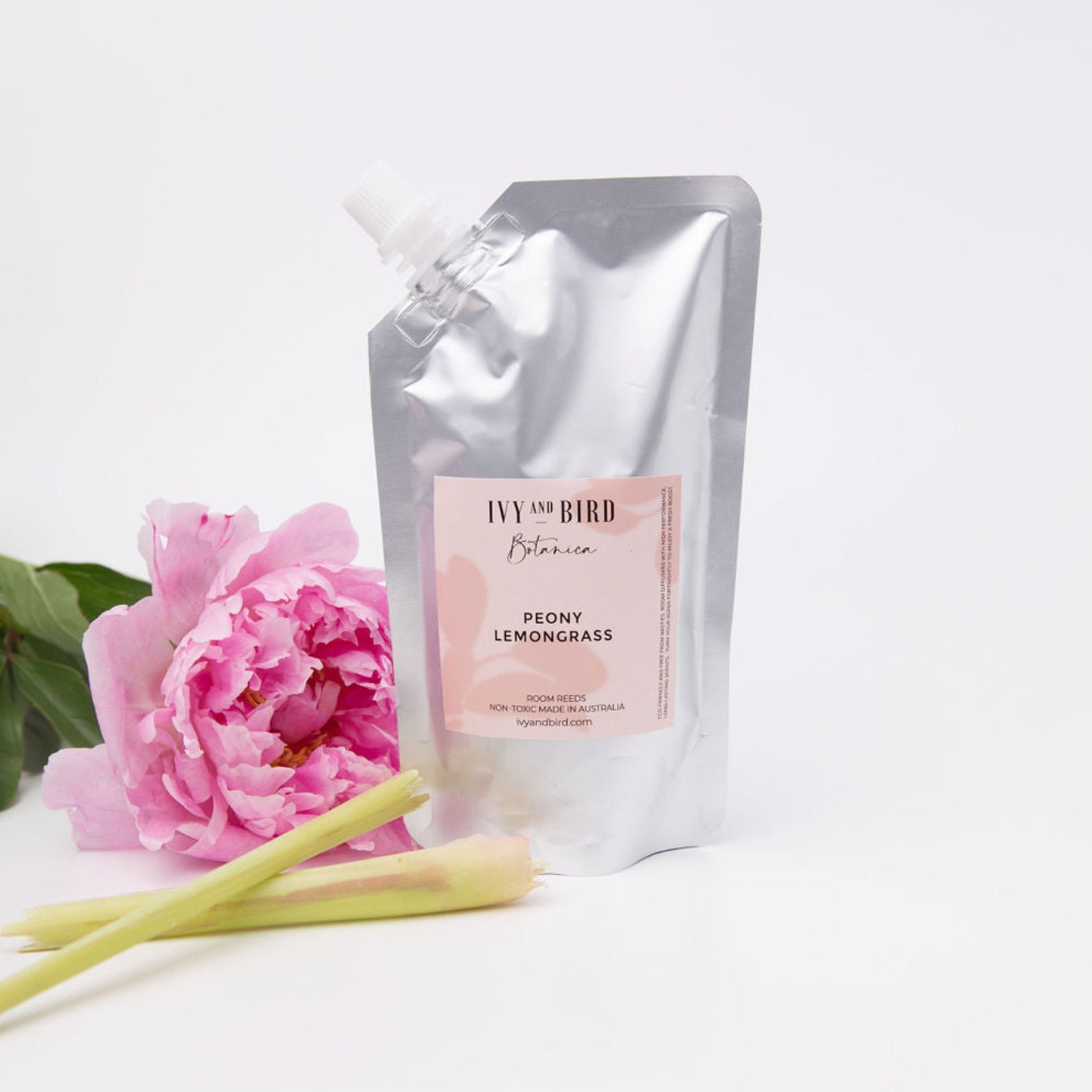 peony and lemongrass room diffuser refill pouch on white background with peony rose flower and lemongrass plant