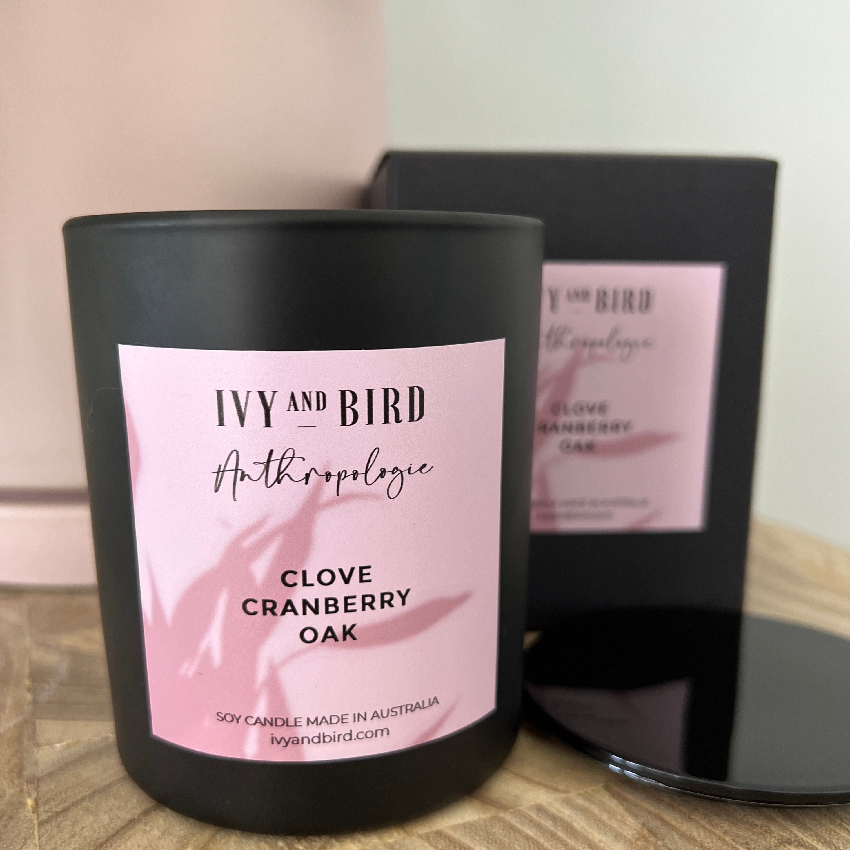 clove cranberry and oak soy candle in matte black glass vessel in black gift box