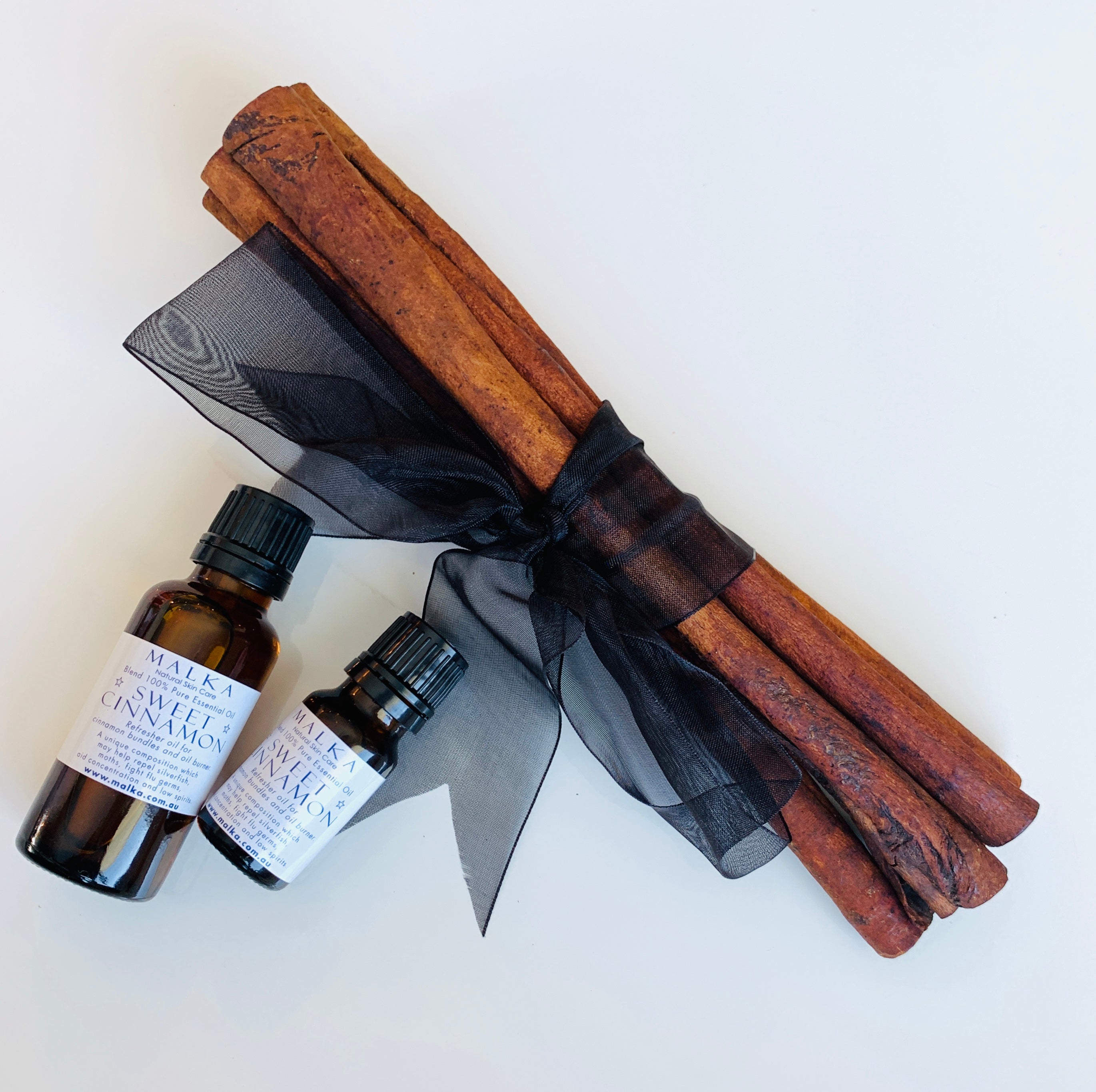 Sweet cinnamon oil drops and cinnamon sticks