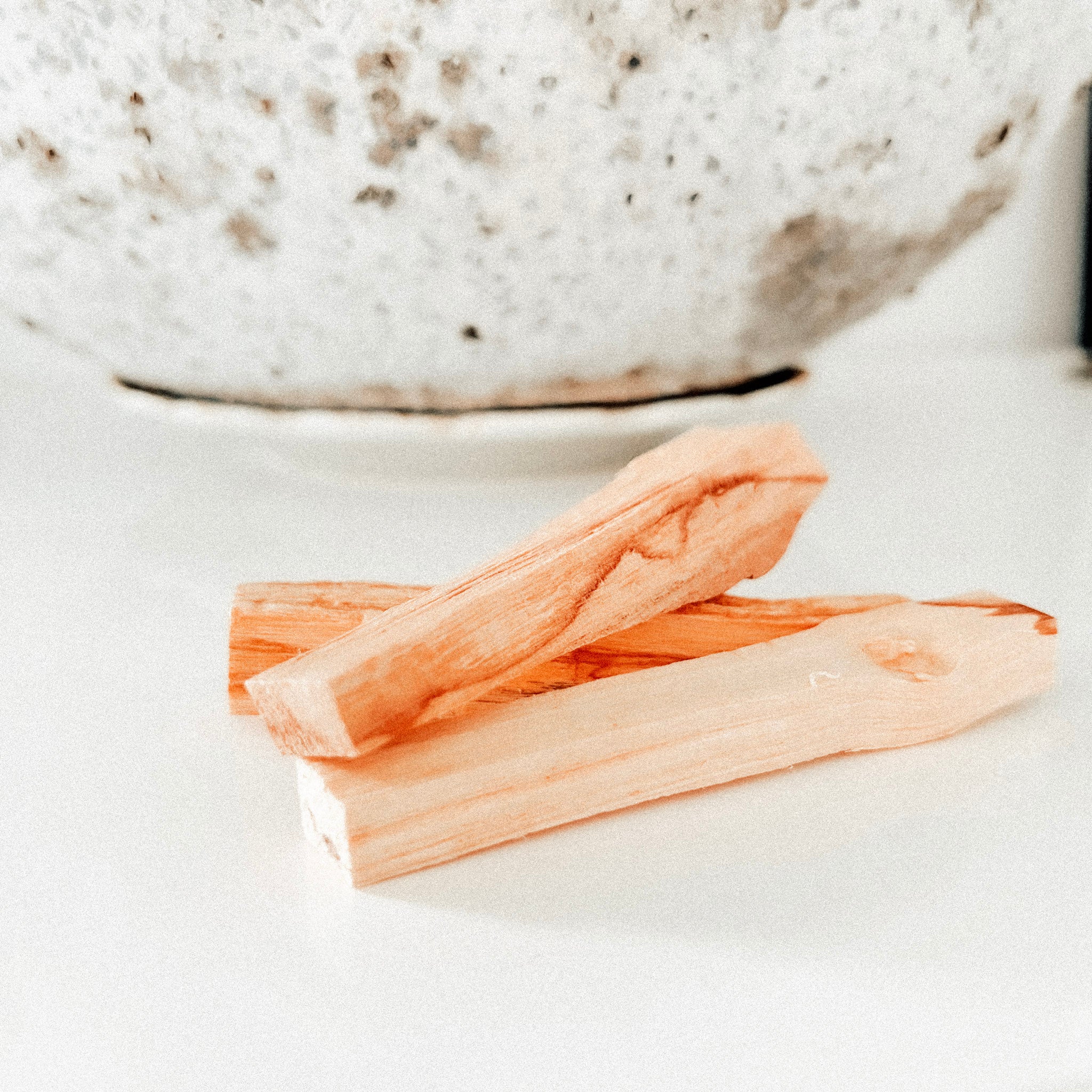 image of palo santo pieces of wood on white surface