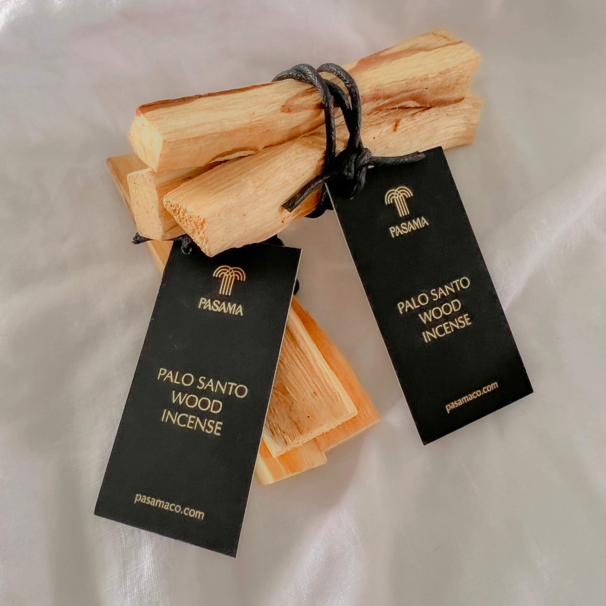 bundles of wrapped palo santo wooden incense 